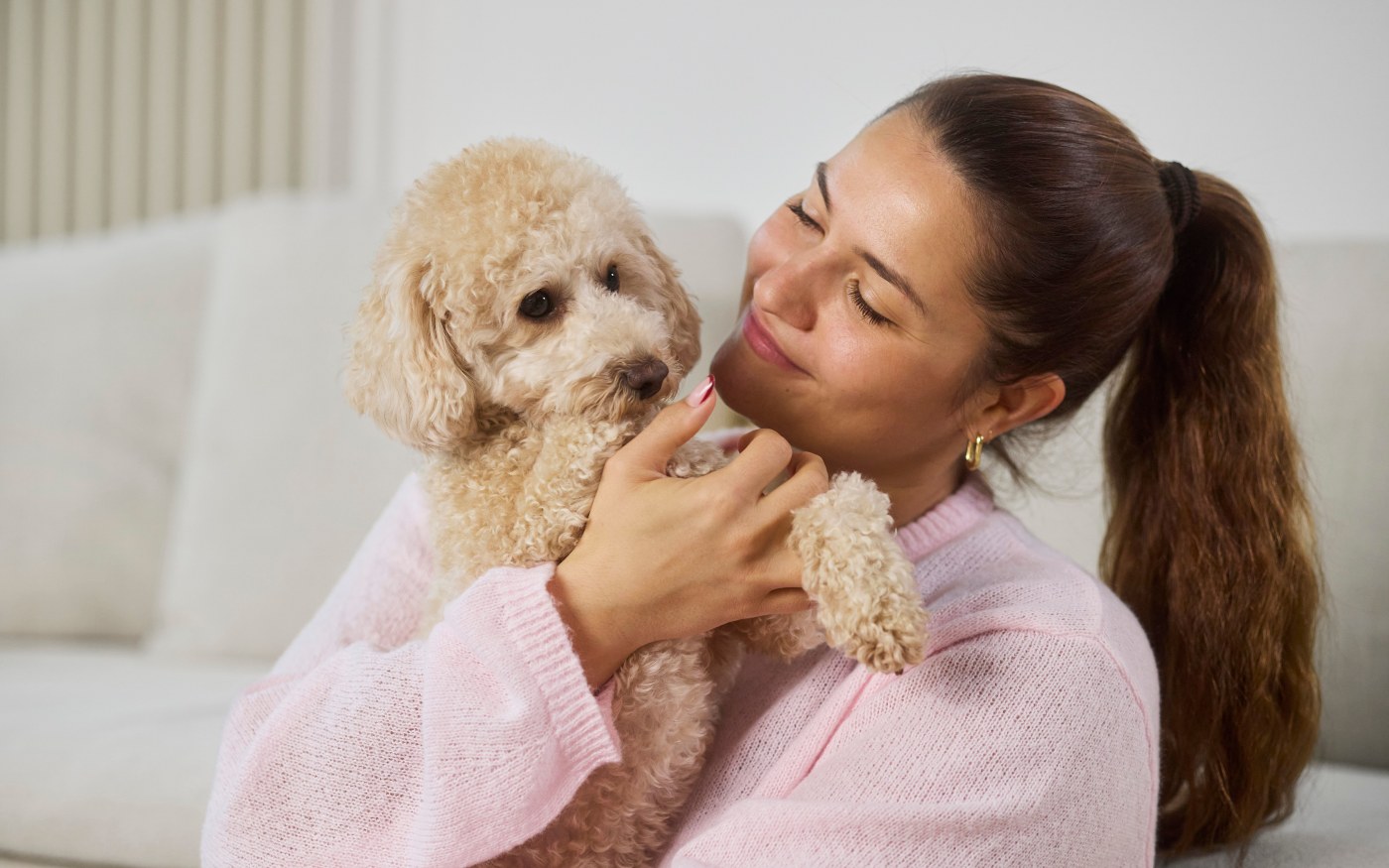 Mujer sosteniendo a su perro en brazos